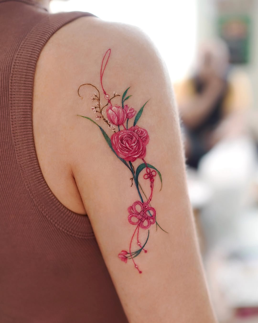 Elegant floral shoulder tattoo bursting with color