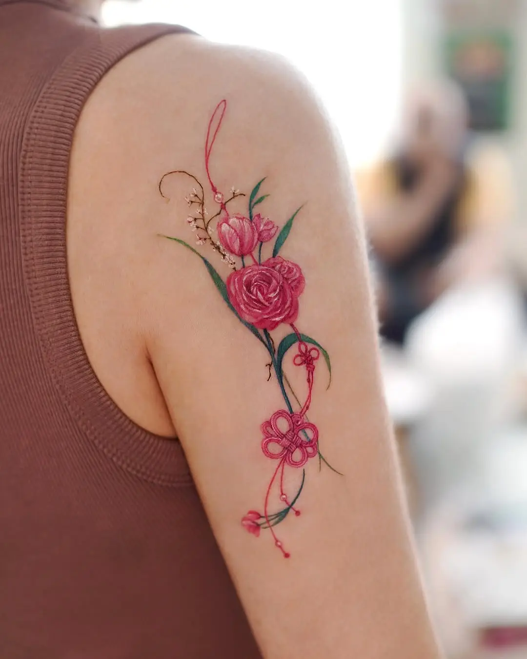 Elegant floral shoulder tattoo bursting with color