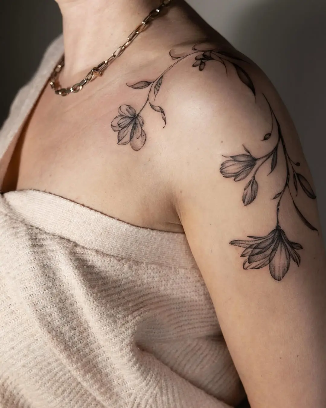 Delicate floral shoulder tattoo with soft lines