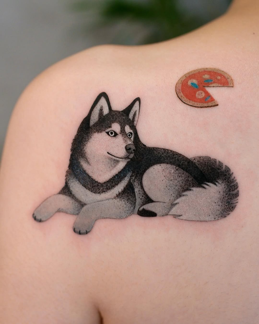 Charming husky with playful pizza slice tattoo