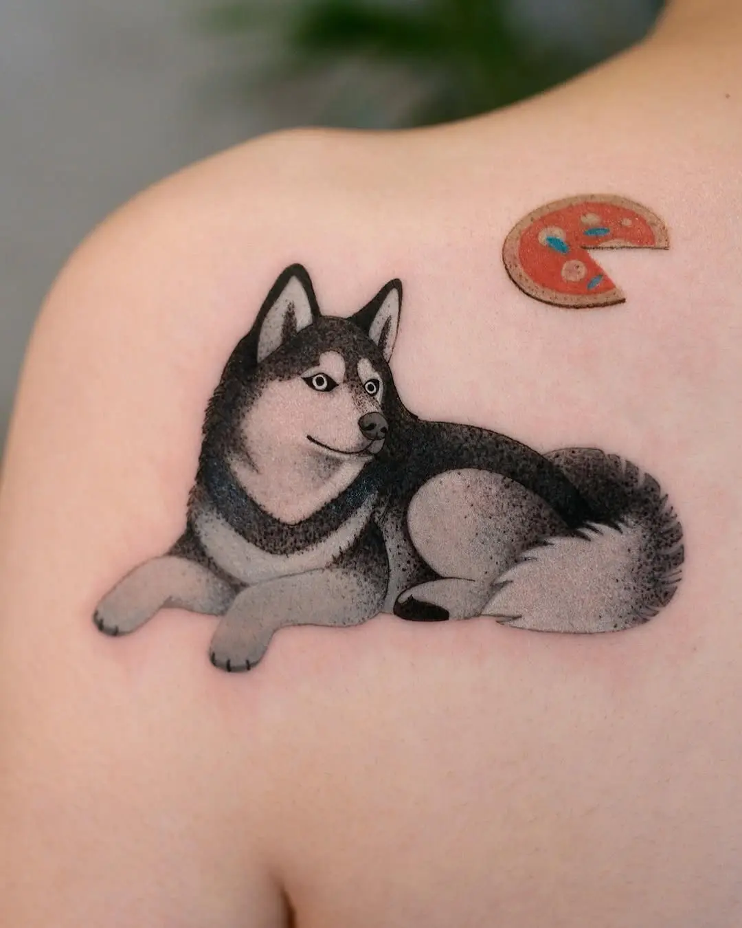 Charming husky with playful pizza slice tattoo