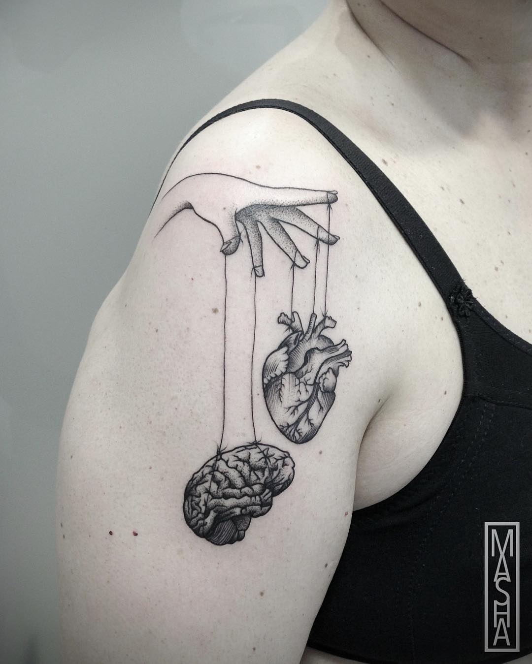 Intricate brain and heart shoulder tattoo design