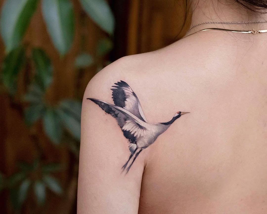 Elegant crane tattoo on shoulder