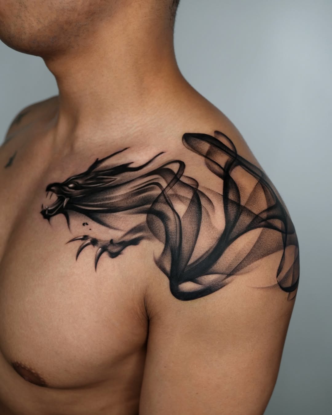 Dynamic dragon design on shoulder tattoo