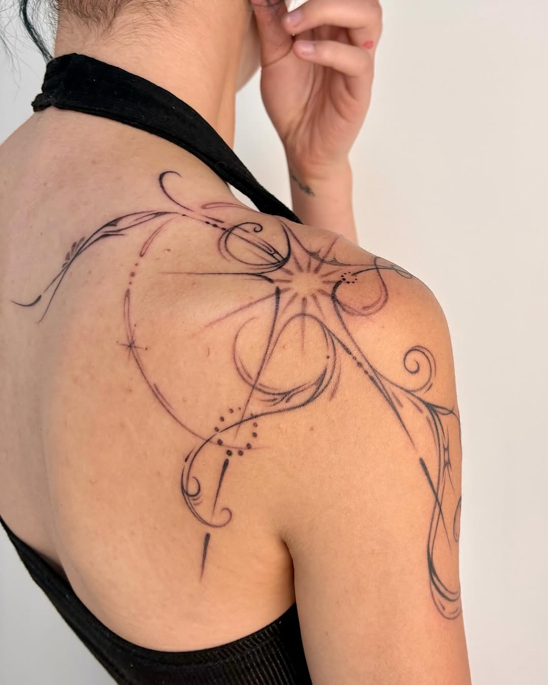 Elegant black ink shoulder tattoo design
