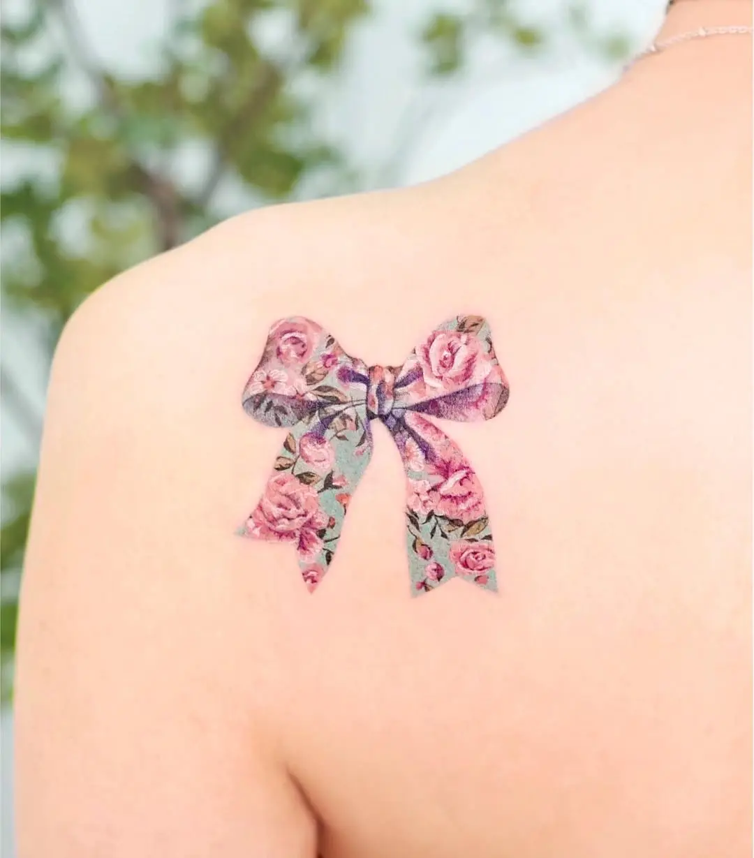 Elegant floral bow tattoo on shoulder