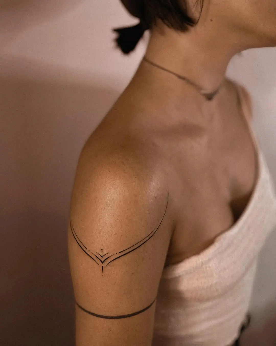 Elegant minimalist black line shoulder tattoo
