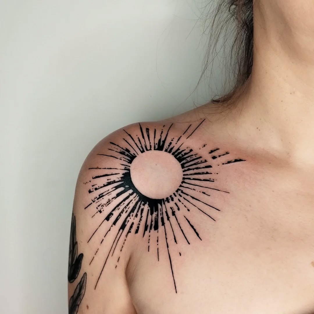 Modern sunburst tattoo on shoulder