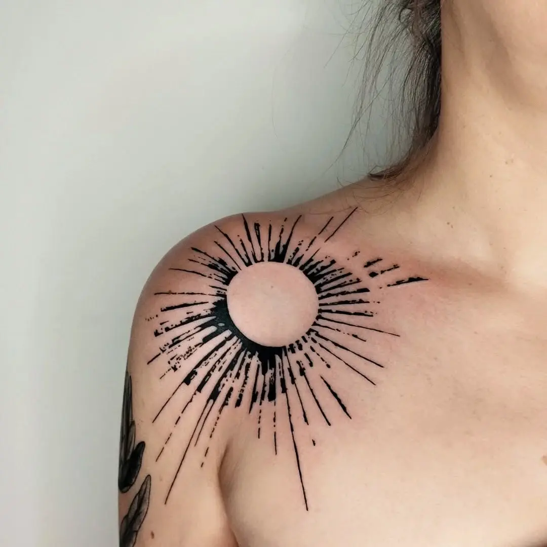 Modern sunburst tattoo on shoulder