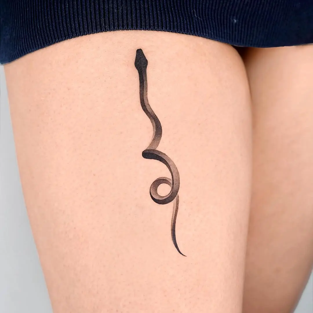 Sleek Black Snake Tattoo on Thigh
