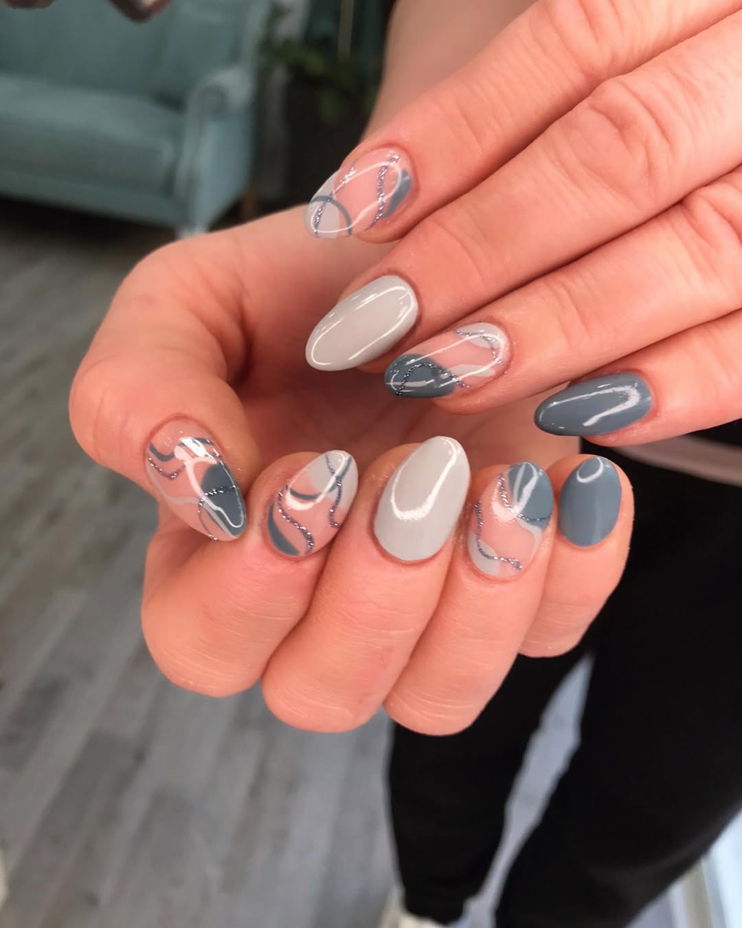 Elegantly designed grey nails with artistic flair