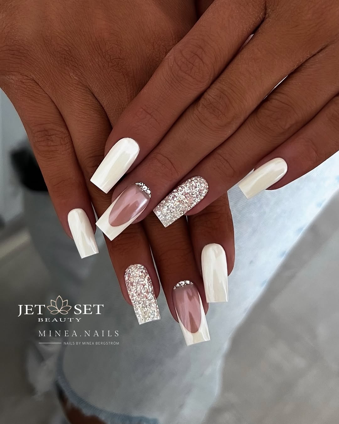 Elegant white nails with stunning glitter accents