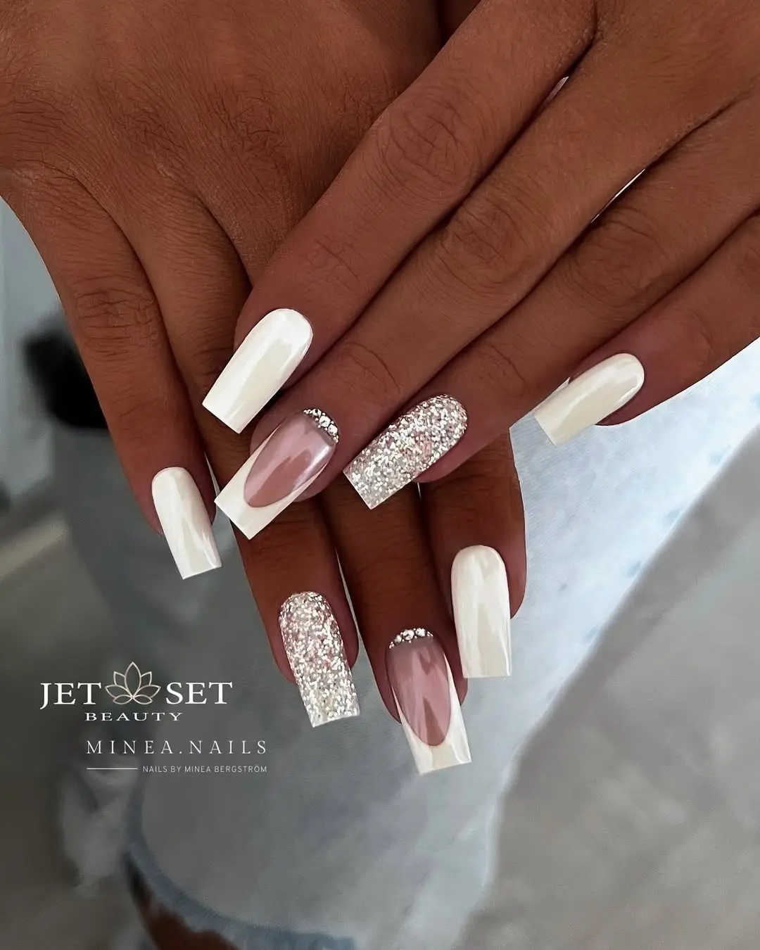 Elegant white nails with stunning glitter accents