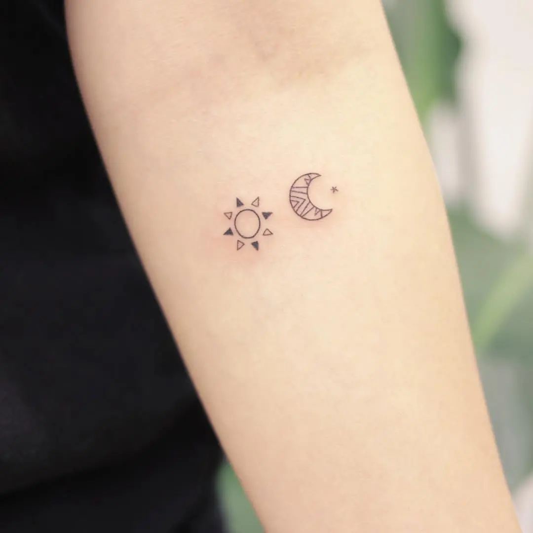 Charming sun and moon tattoo pair on arm
