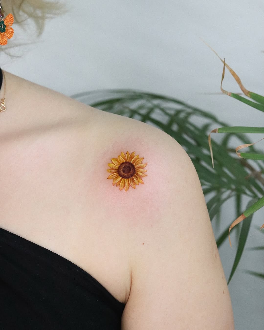Vibrant sunflower tattoo on shoulder