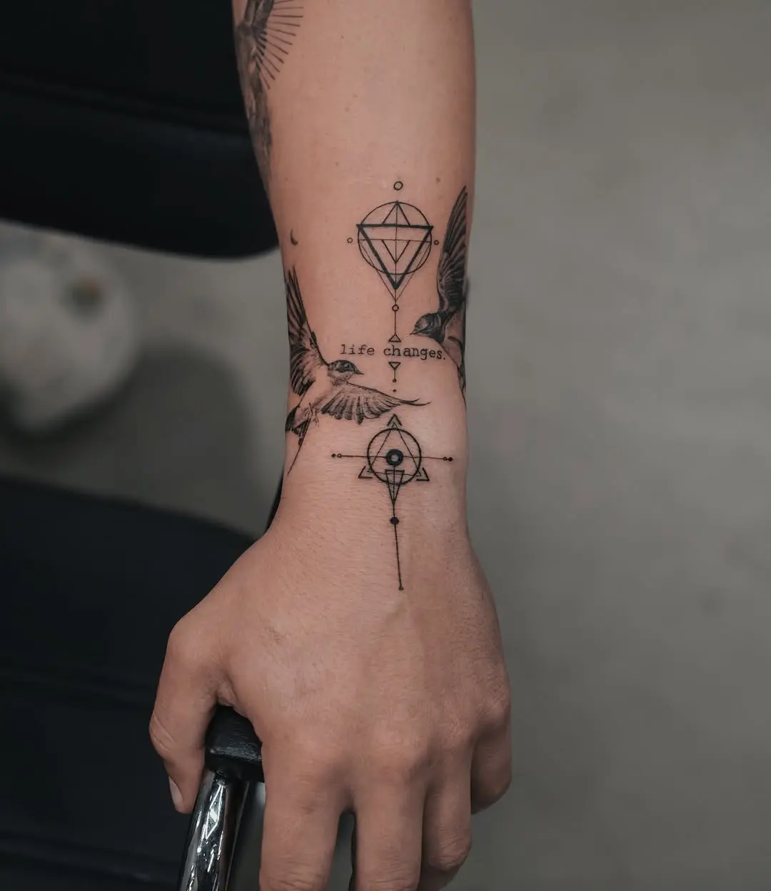 Elegant Swallow Tattoo with Symbolic Elements