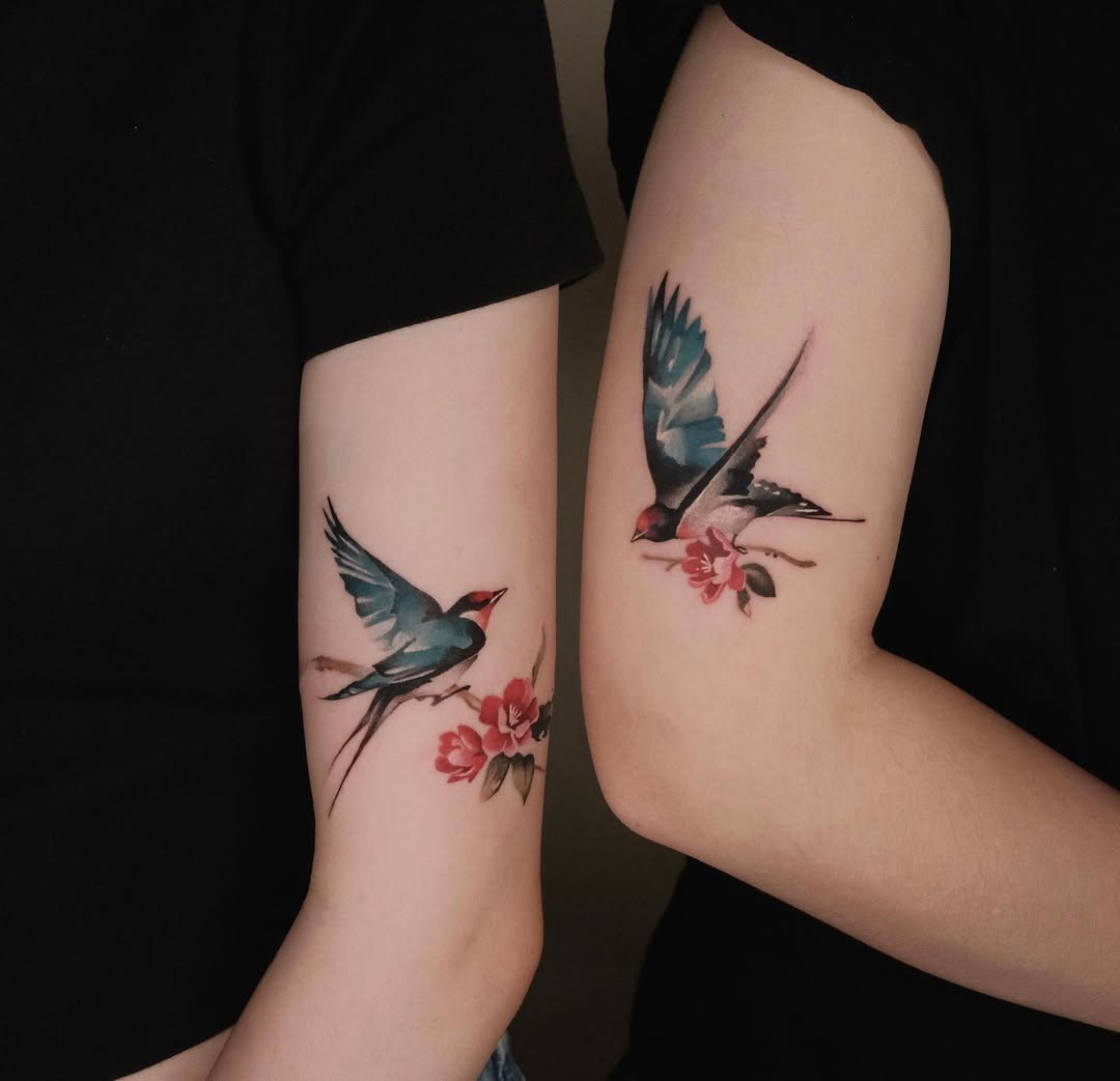 Elegant swallow tattoos with floral accents
