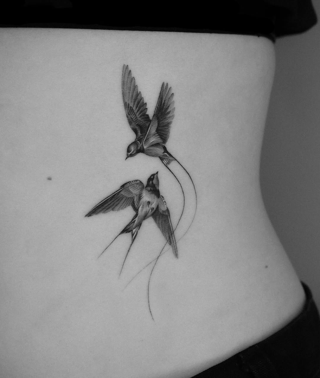 Graceful swallows in flight tattoo design