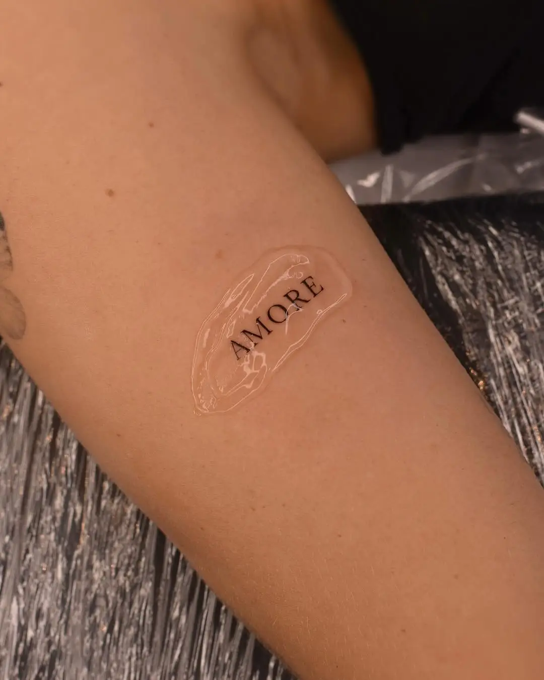 Elegant 'Amore' Tattoo Design on Skin