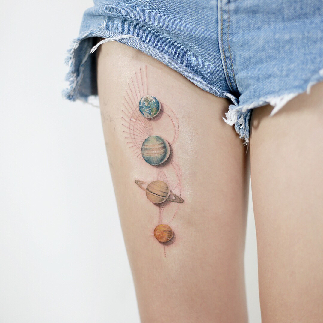 Stunning celestial-themed thigh tattoo design