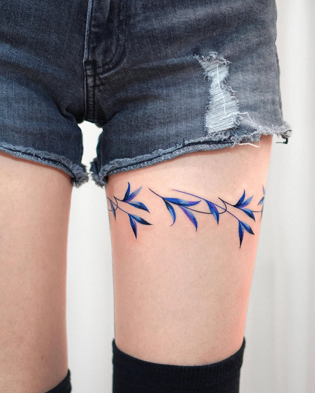 Elegant bamboo tattoo design on the thigh