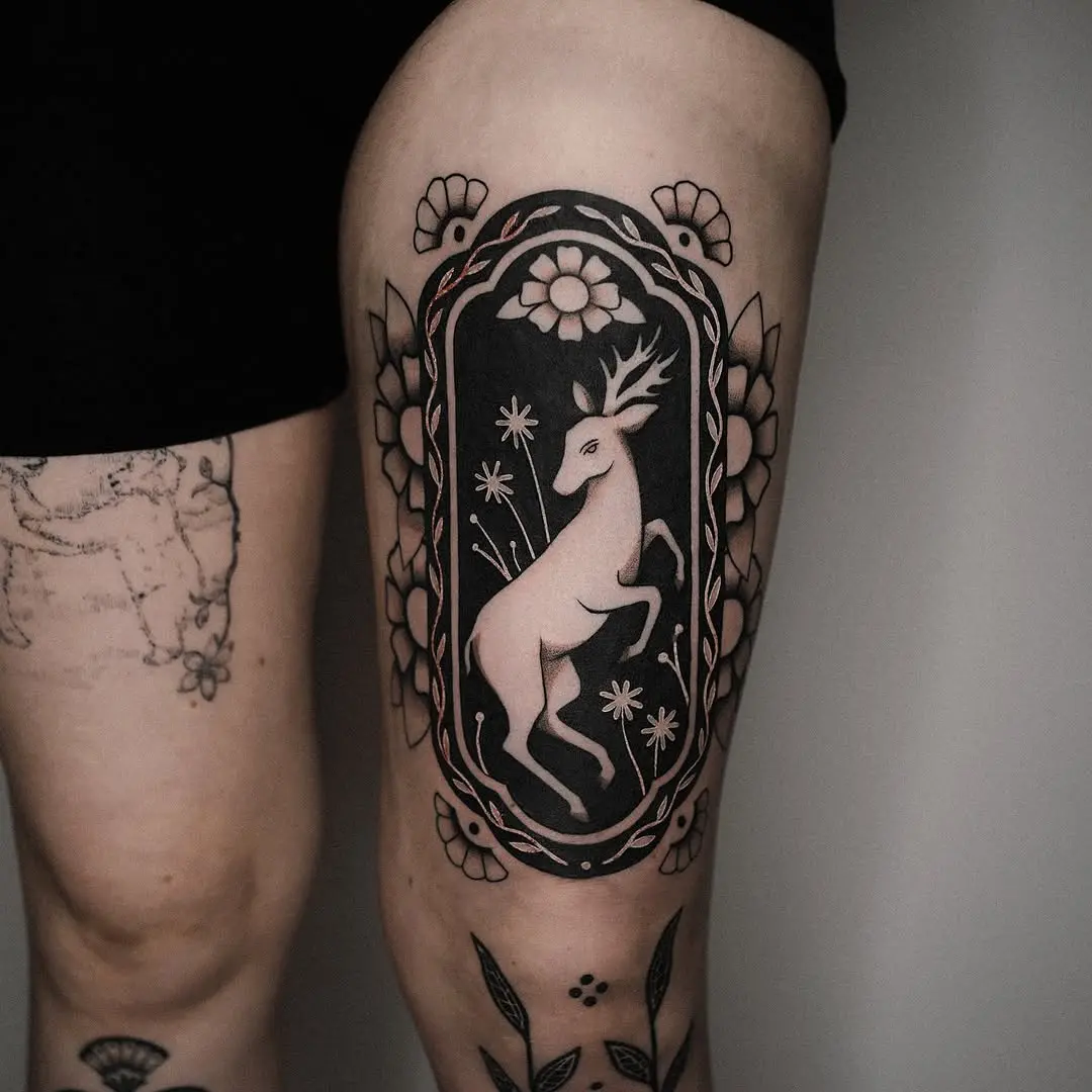 Stunning deer tattoo in floral frame