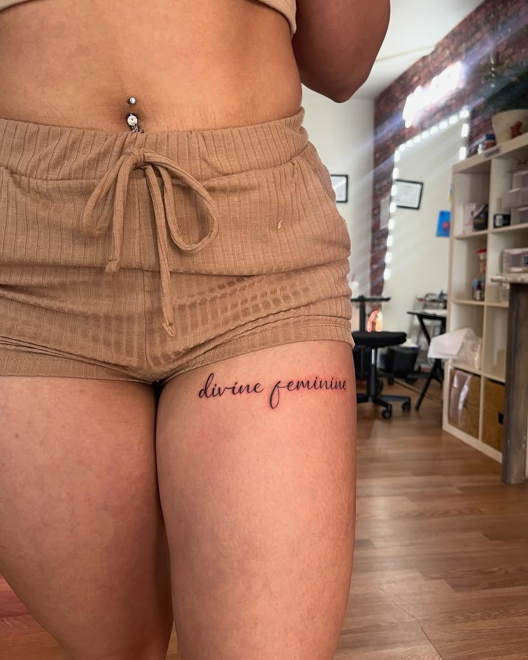 Elegant script tattoo enhancing feminine energy