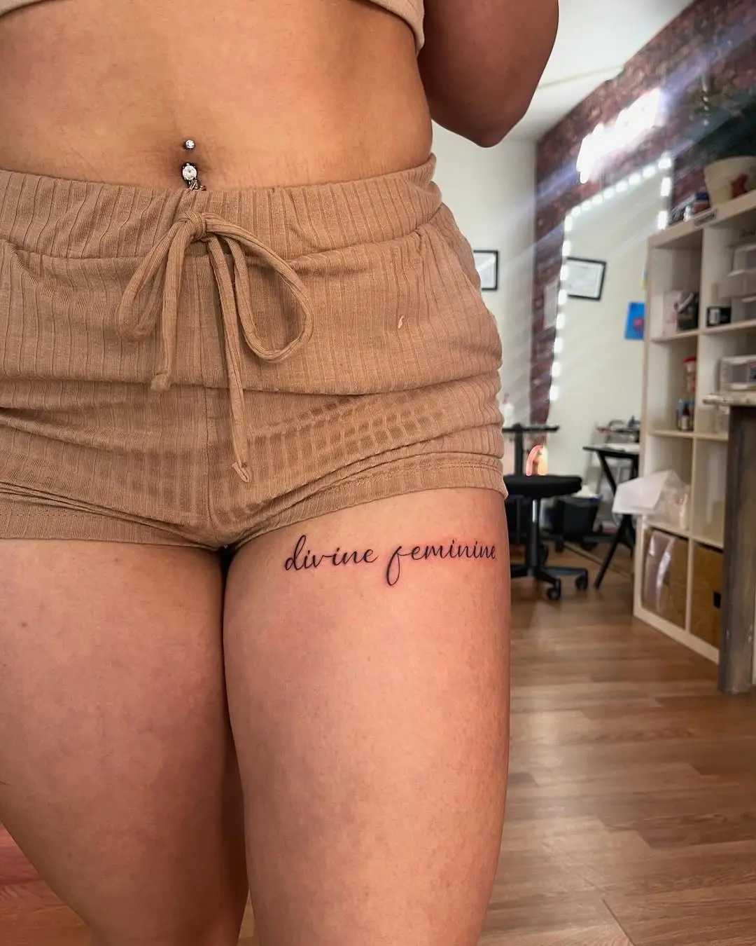 Elegant script tattoo enhancing feminine energy