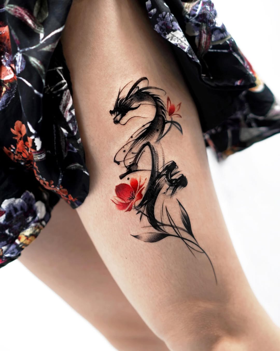 Elegant dragon tattoo with floral accents