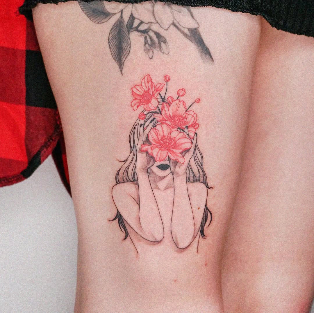 A captivating flower girl thigh tattoo