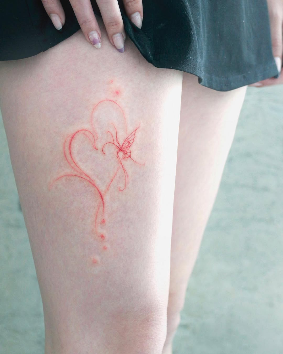 Delicate heart tattoo with floral design