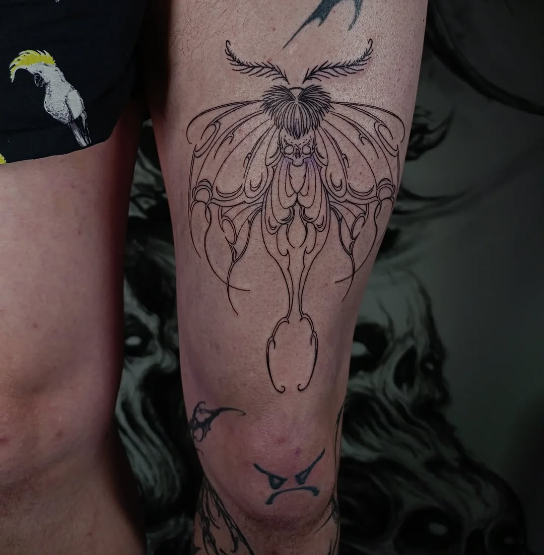 Elegant moth tattoo design on thigh