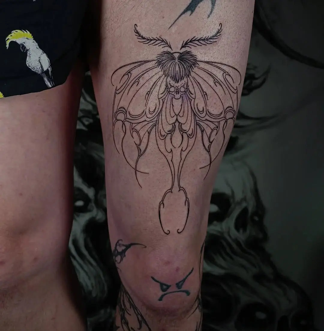 Elegant moth tattoo design on thigh