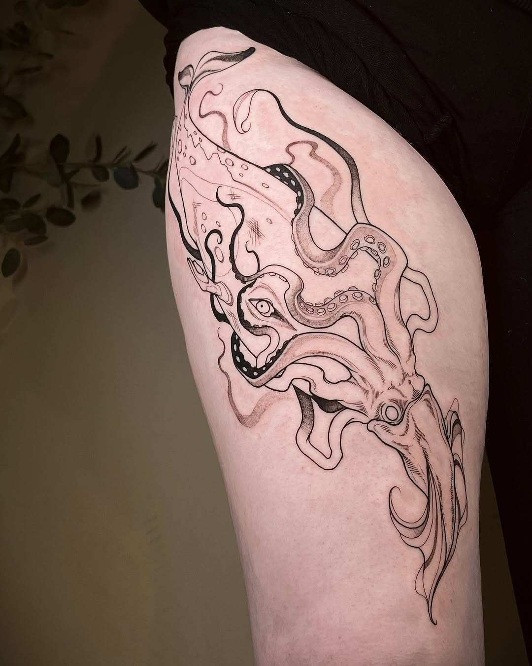 Intricate squid tattoo embodies ocean elegance
