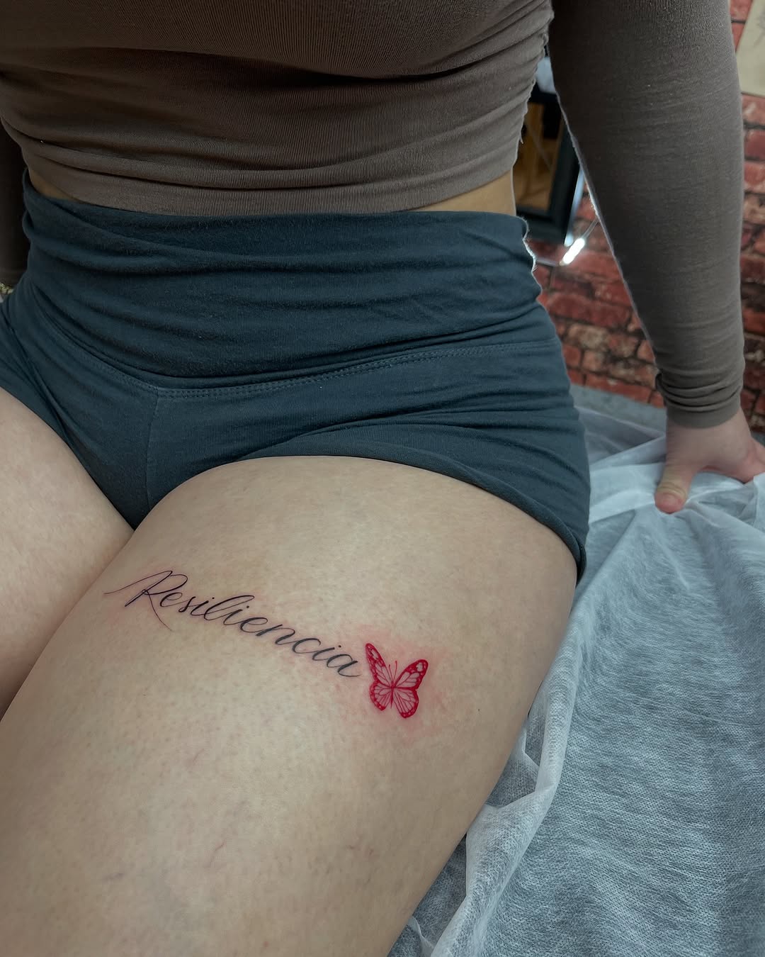 Elegant thigh tattoo featuring a butterfly design