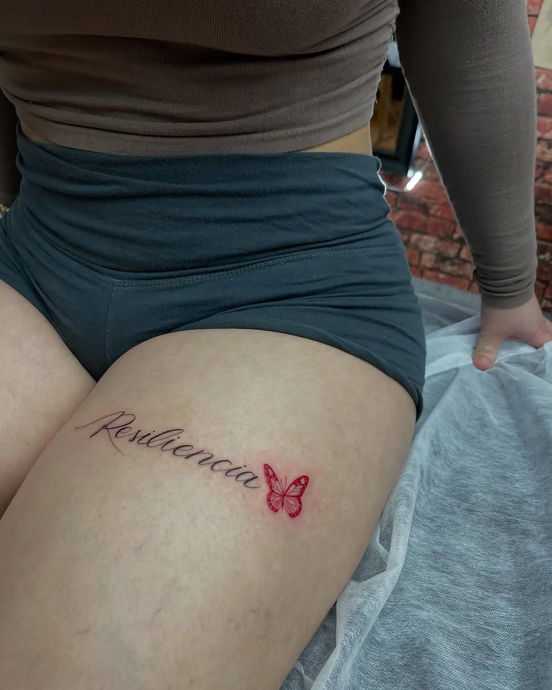 Elegant thigh tattoo featuring a butterfly design