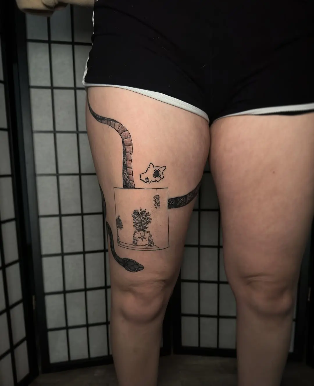 Creative thigh tattoo with modern themes
