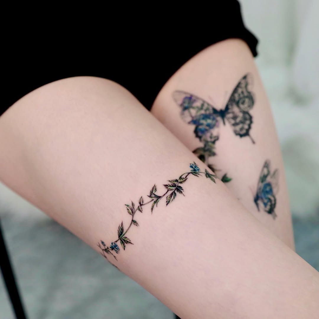 Elegant floral vine tattoo on the thigh