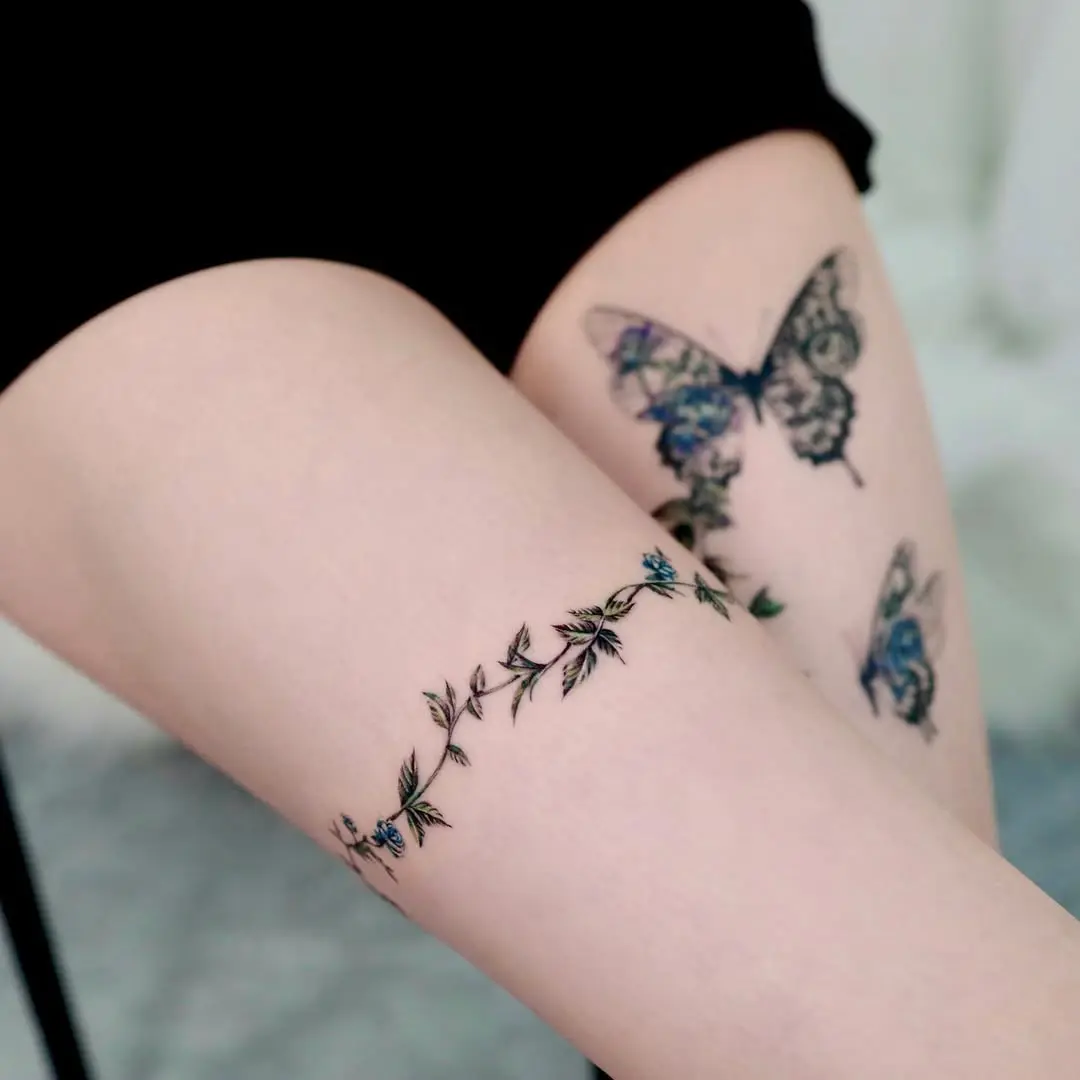 Elegant floral vine tattoo on the thigh