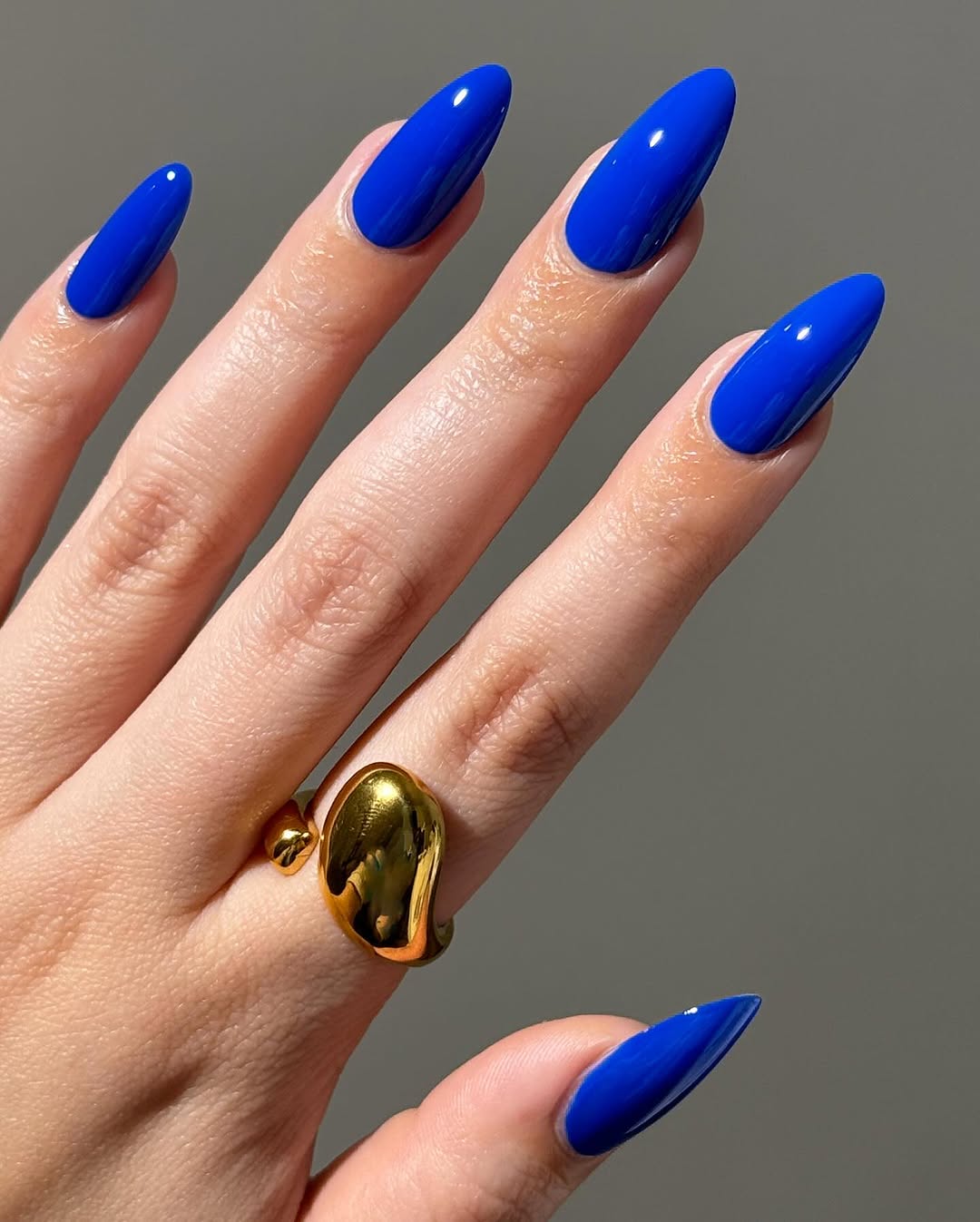 Vibrant blue nails with a glossy finish