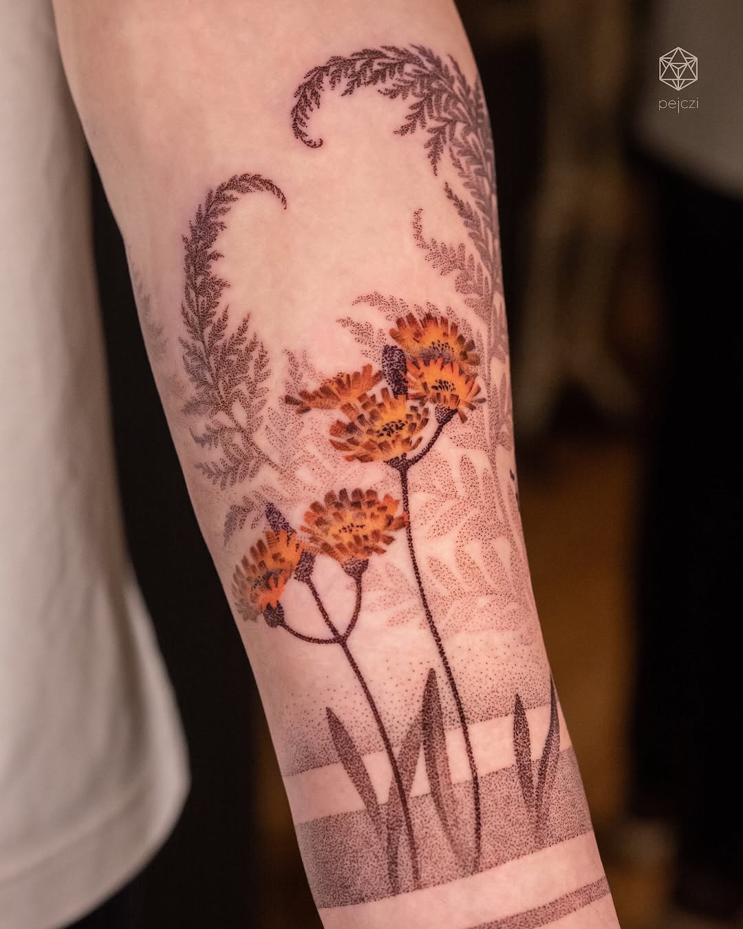 Stunning arm tattoo featuring vibrant flowers
