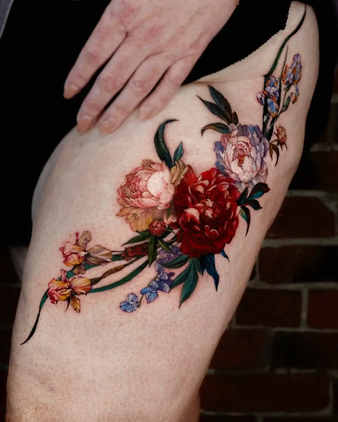 Stunning floral thigh tattoo with vibrant hues