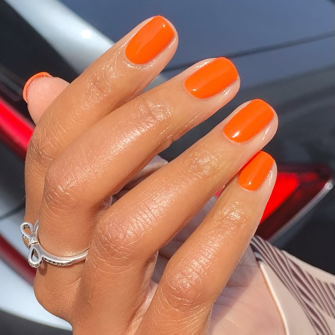 Vibrant orange nails for summer vibes