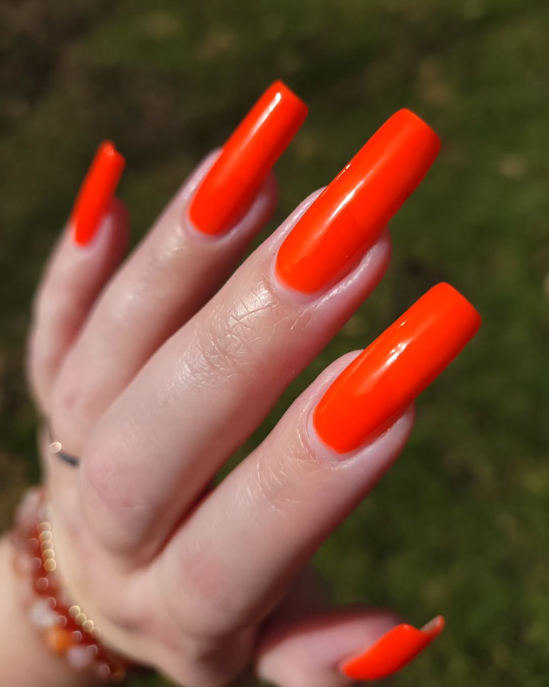 Bright orange nails for bold summer vibes