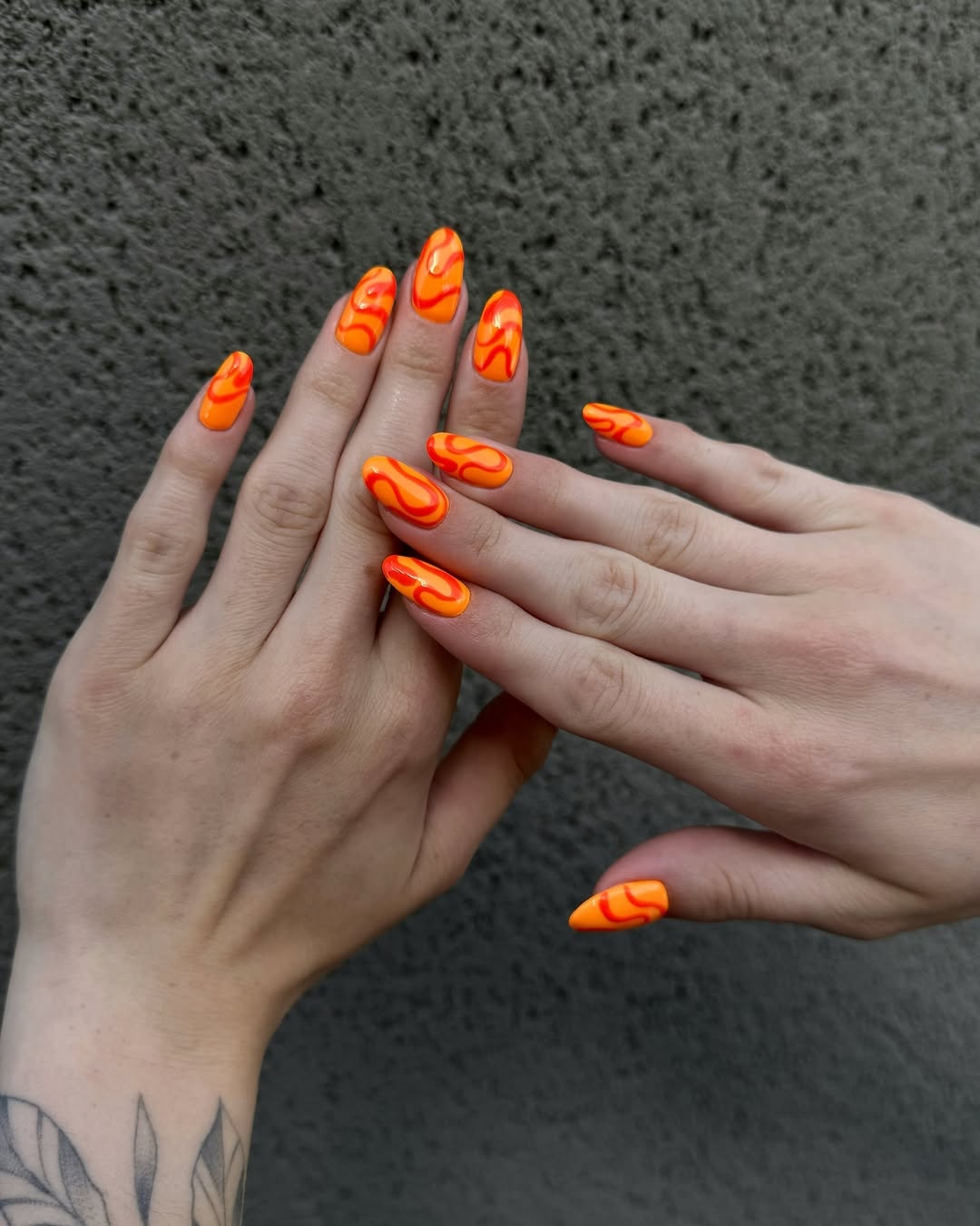 Trendy orange nails with flame accents
