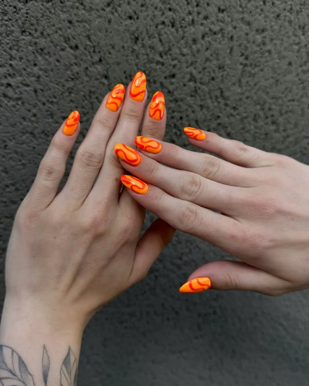 Trendy orange nails with flame accents