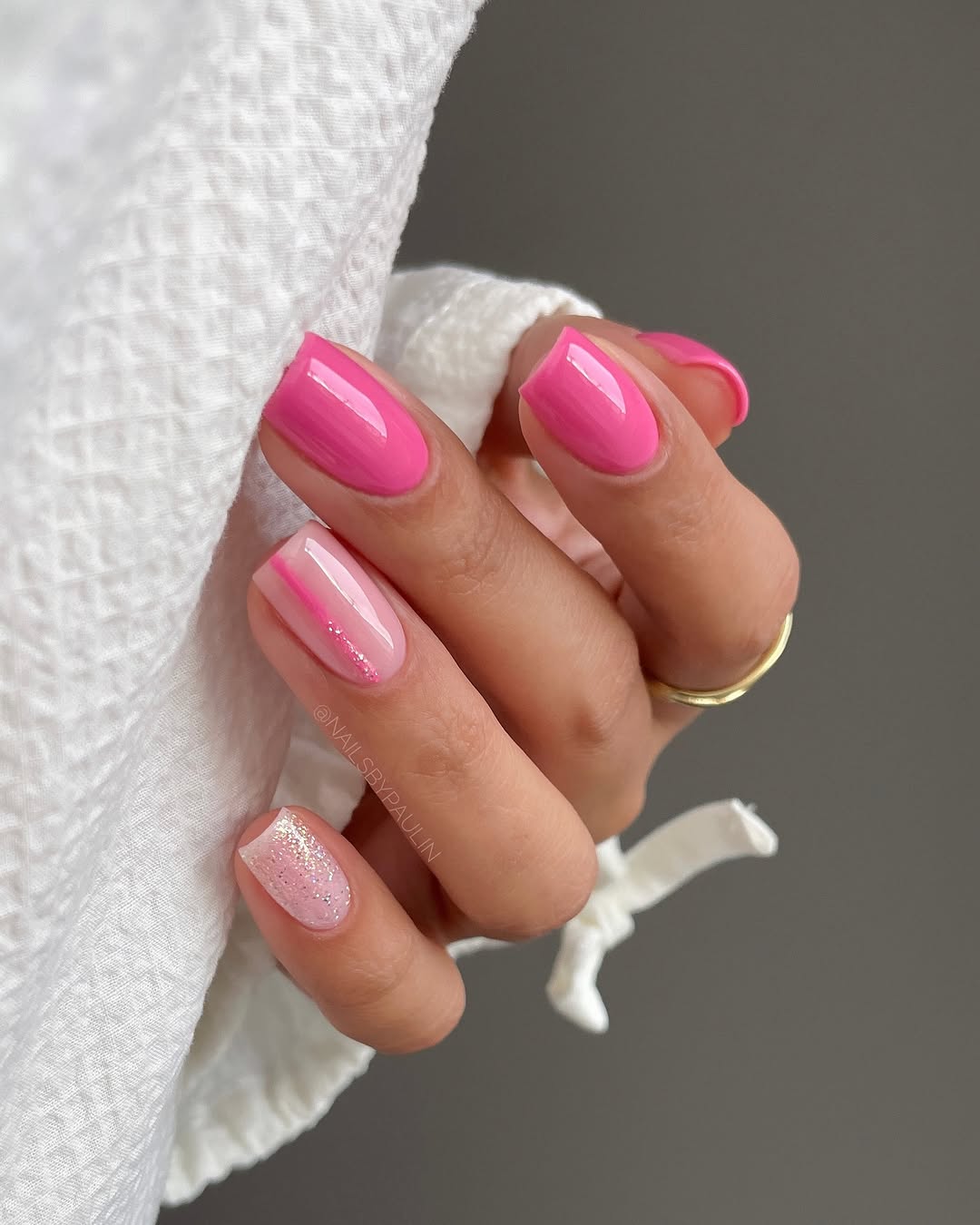 Chic pink nails with a glittery accent