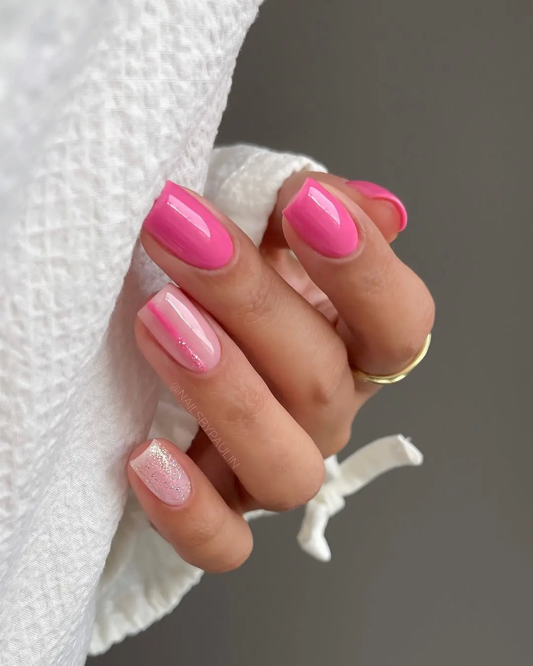 Chic pink nails with a glittery accent