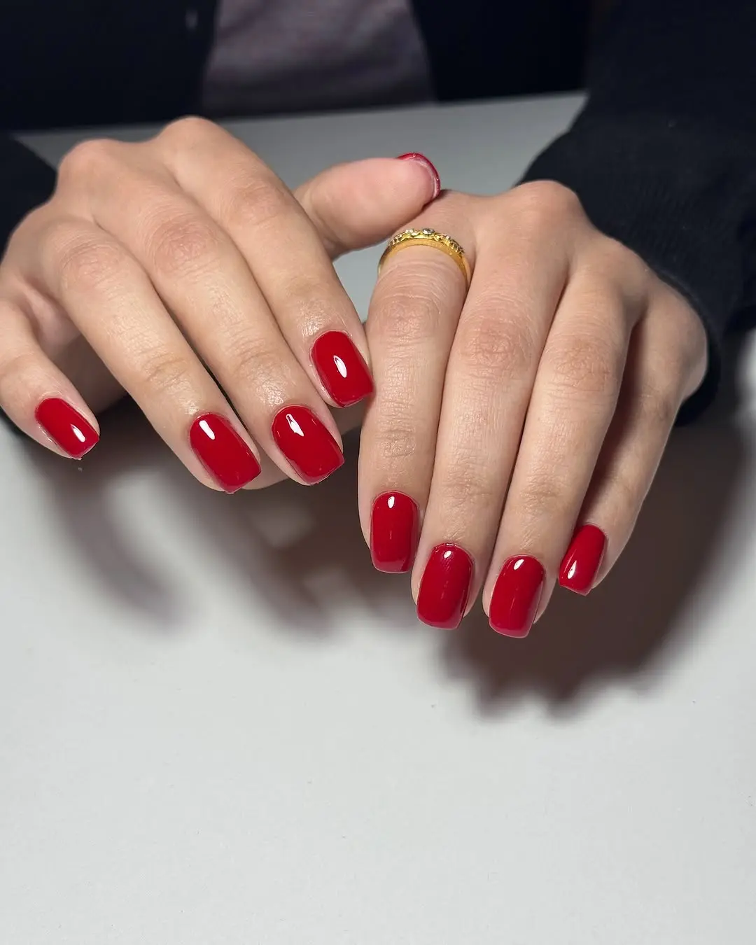 Glossy vibrant red manicure showcasing elegance