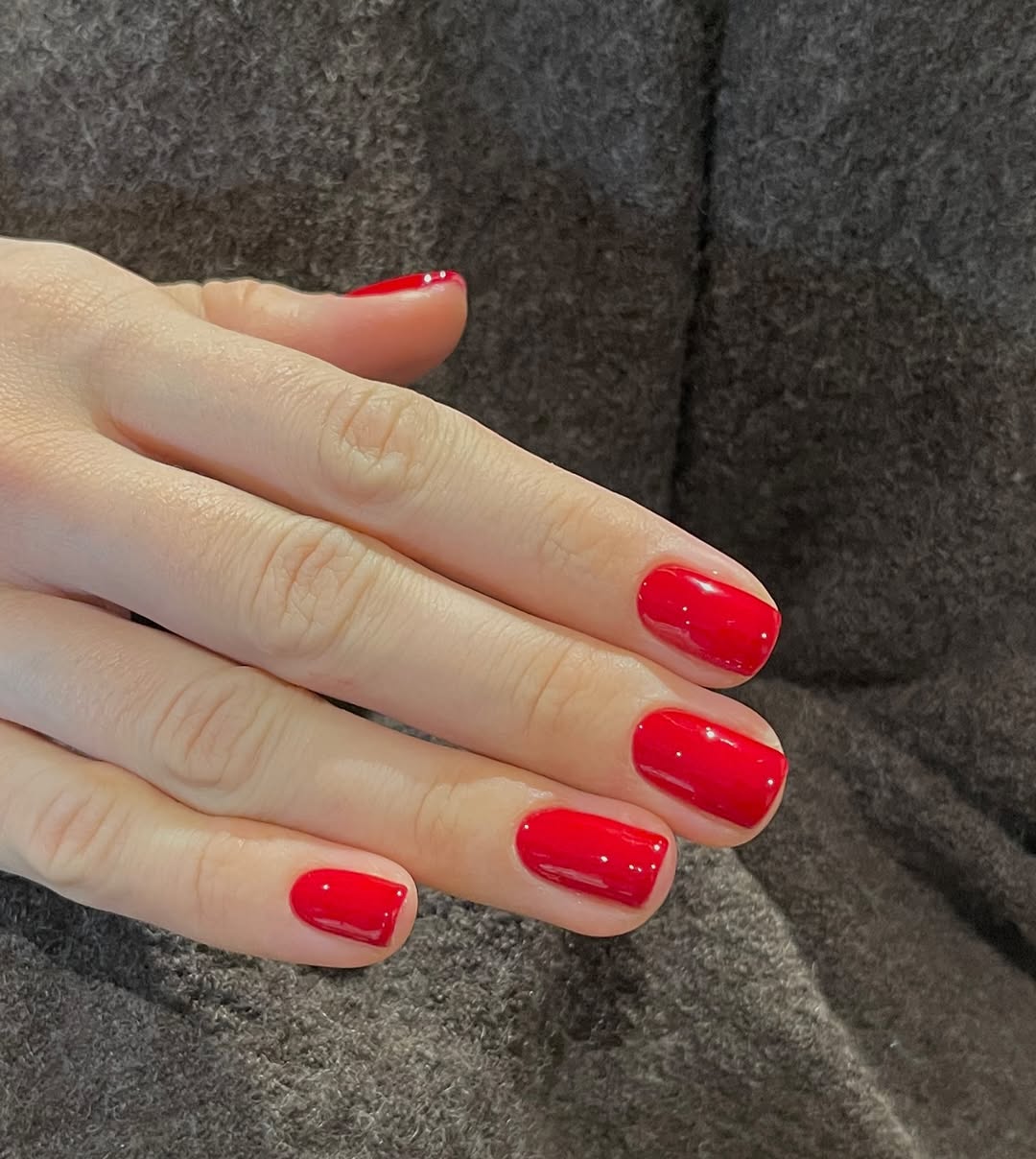 Captivating red nails on elegantly manicured hands